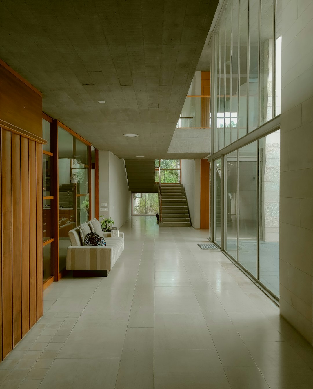 a-long-hallway-with-a-couch-and-stairs-rsjbgc1fhqm